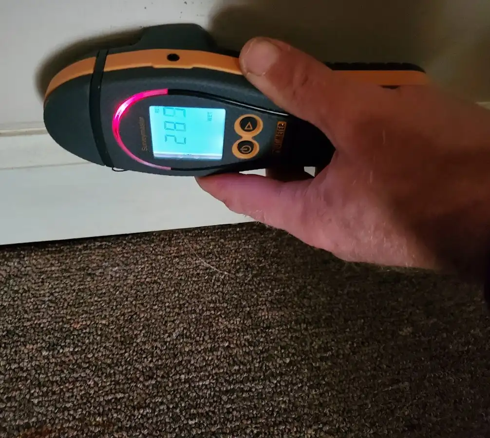 Moisture detection at baseboard during Storm Damage Restoration in Reynolds